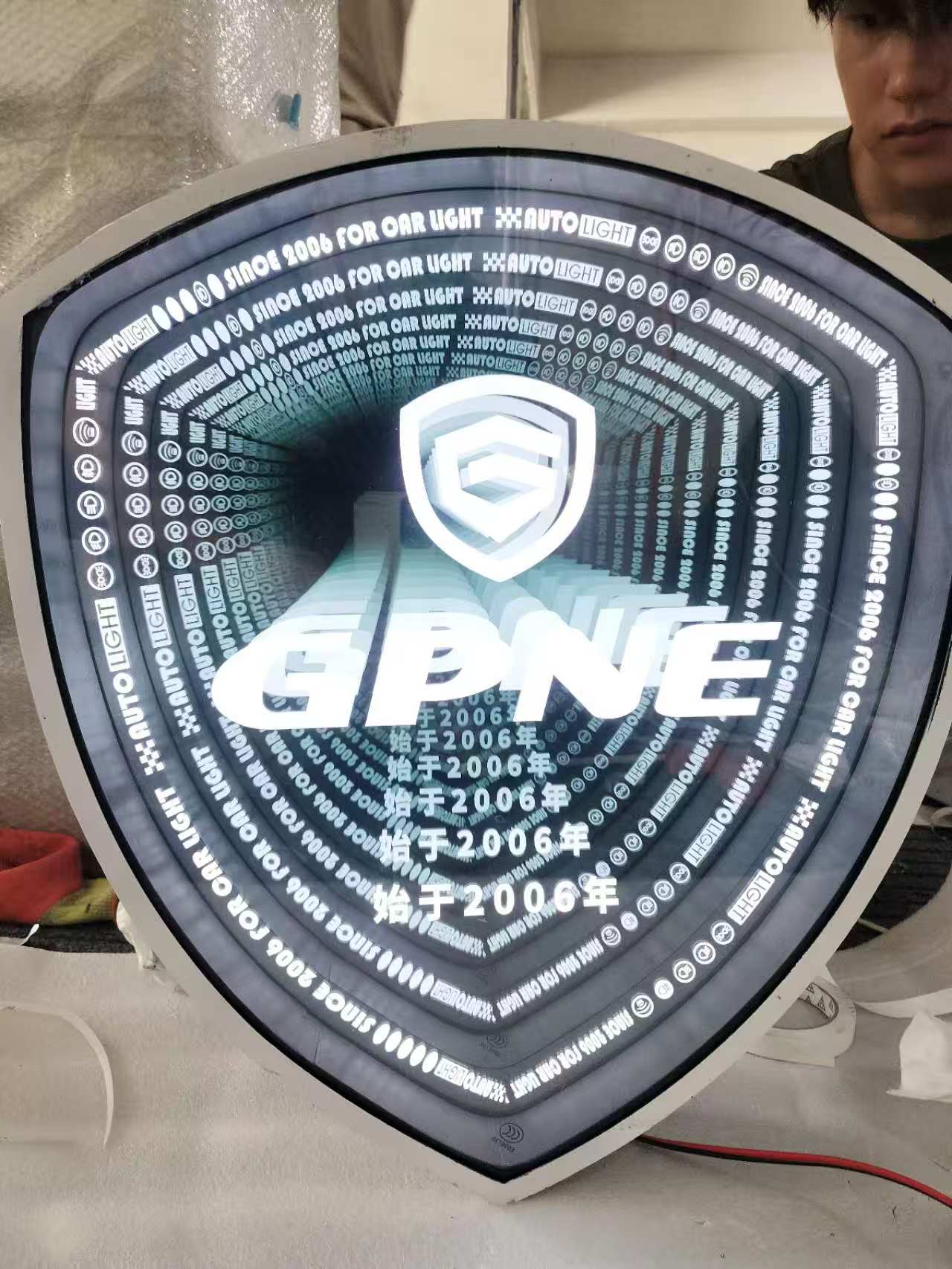 Shield Shape Infinity Mirror Wall Art – Blue Gray LED Illusion Light with White Text, 3D Futuristic Tunnel Decor for Home & Office